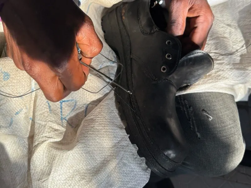 Stitching a shoe in Waweza's leather and shoe training